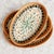 Set of three oval decorative trays with hand-woven edges made of natural rattan and mother-of-pearl inlay on the surface....