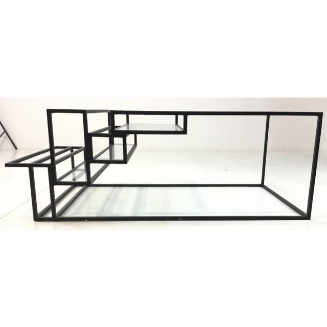 Stylish industrial modern metal and glass cocktail table, unique architectural detail, showroom floor sample