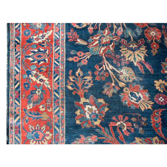 An incredible early 20th century Persian Mohajeran rug with a beautiful central floral medallion living amidst a field of...