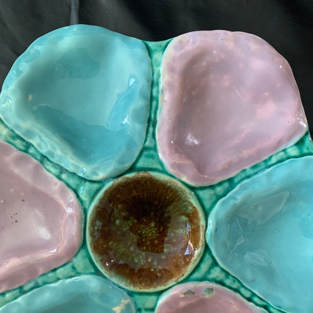 This is an antique 19th-century English Victorian majolica oyster plate featuring alternating turquoise and lilac wells...