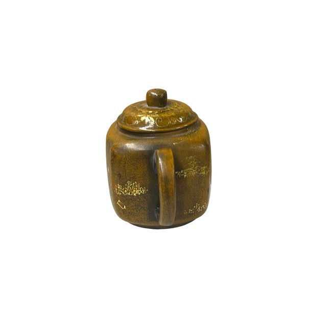 This is a small, square-bodied clay teapot featuring a rich, mottled mustard-yellow to brown glaze with a distinct,...