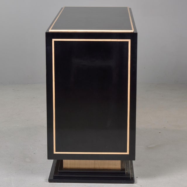 Found in Italy, this black lacquer and birch cabinet dates from the 1980s. This Art Deco-inspired cabinet features a...