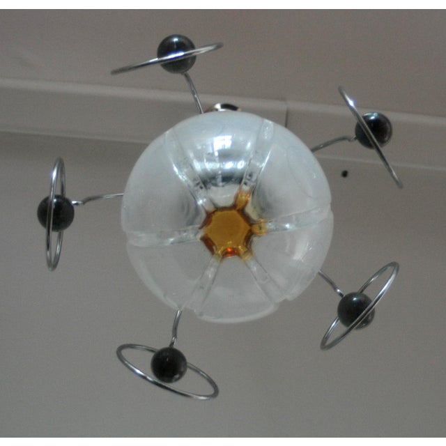 Vintage space-age chandelier from the 1970s, Italy. This elegant piece of vintage lighting perfectly represents the...