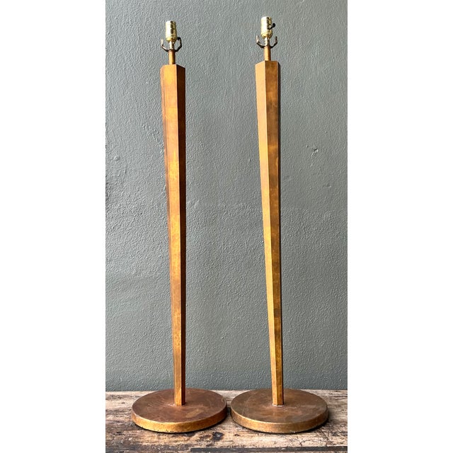 This striking pair of vintage floor lamps showcases a refined mid-century modern aesthetic through streamlined geometry...