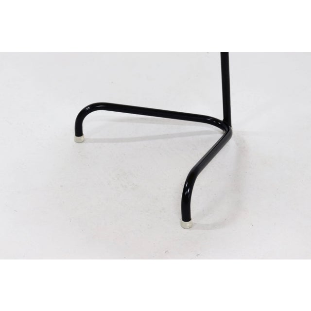 Dutch side table by Kuperus from the 1950s. The table has a steel tripod base with a wooden circular top. I have official...