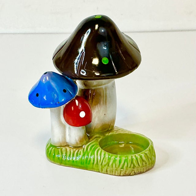 This is a colorful little Votive or Tea Light Candle Holder. It features three mushrooms in a bright red and Royal Blue as...