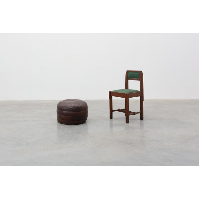 A stylish Swiss patchwork leather pouf dating from the 1970s. Crafted from stitched panels of rich brown leather, the...