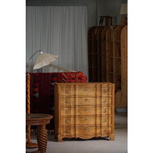 A characterful chest of drawers attributed to Henning (Henry) Kjærnulf, crafted in oak. Made in Denmark in the 1960s. The...