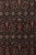 Hand-knotted in wool, this antique 9x13 Doroksh rug dates to circa 1800. The design features an intricate all-over pattern...