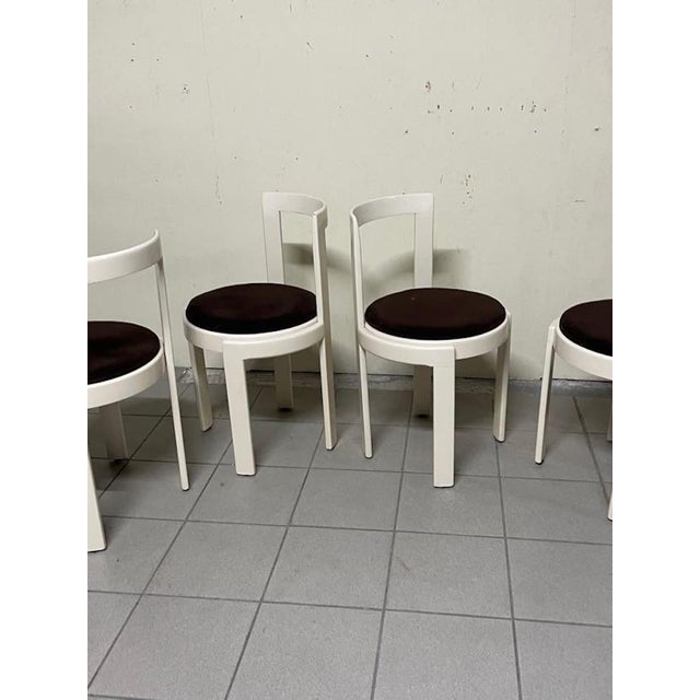 Set of four 1970s chairs with a white lacquered wooden frame and a circular, fabric-upholstered seat. The circular seat...