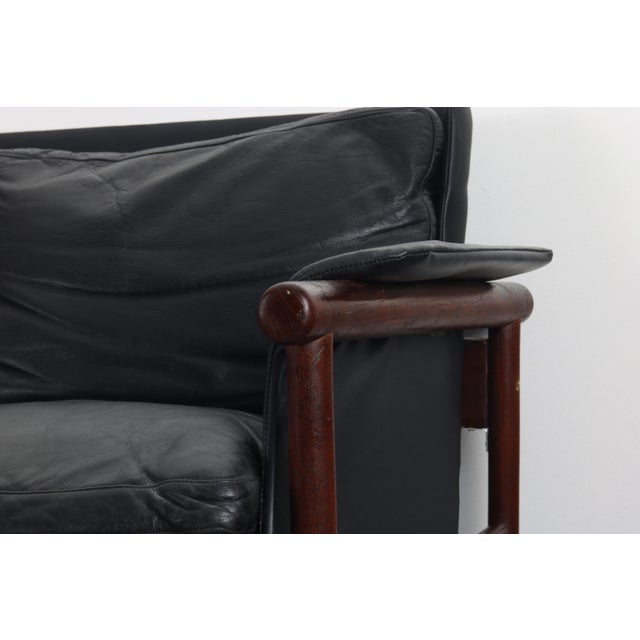Rare Black leather and teak sofa designed by Illum Wikkelsø by Koefoed's Møbelfabrik,,Denmark,1966. Features a solid teak...