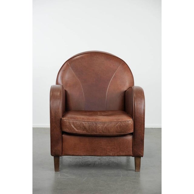 We are offering this beautiful art deco design armchair made of cowhide leather in English style with a beautiful rounded...
