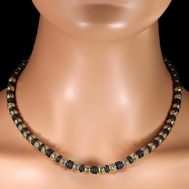 This 18‑inch necklace blends **gold‑washed lava rock** with **matte black onyx rondels** to create a striking play of...