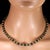 This 18‑inch necklace blends **gold‑washed lava rock** with **matte black onyx rondels** to create a striking play of...
