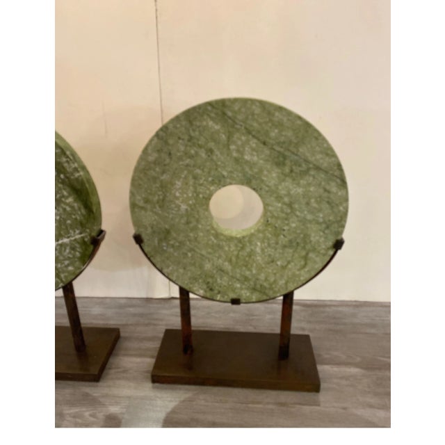 A pair of large round hardstone or marble Chinese sculptures with custom aged steel bases. the stone circles are 24...