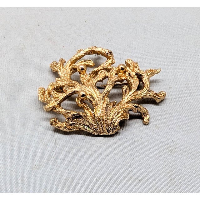 Circa 1972-4 goldtone coral with bumps textured brooch with security clasp. Marked "NAPIER©" on the back. Measures: 1 1/2...