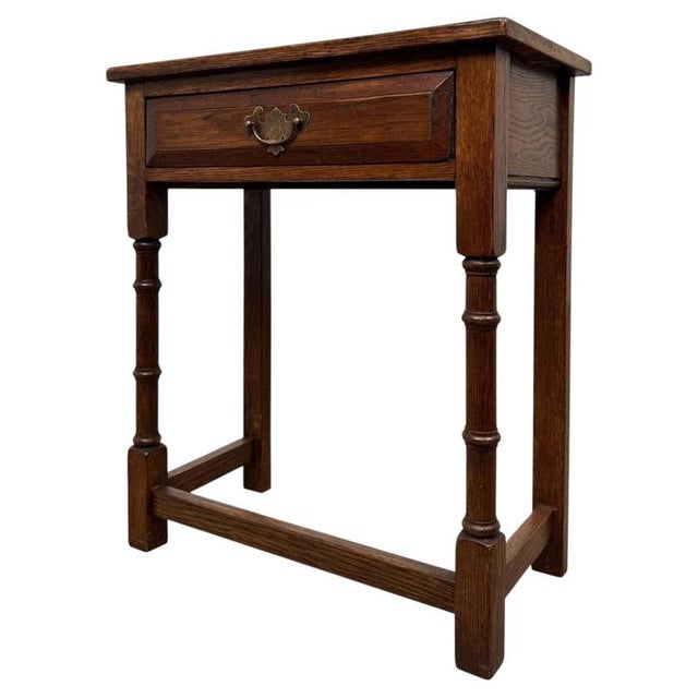 A charming and well-crafted 20th-century small side table, beautifully constructed in oak and distinguished by its compact...