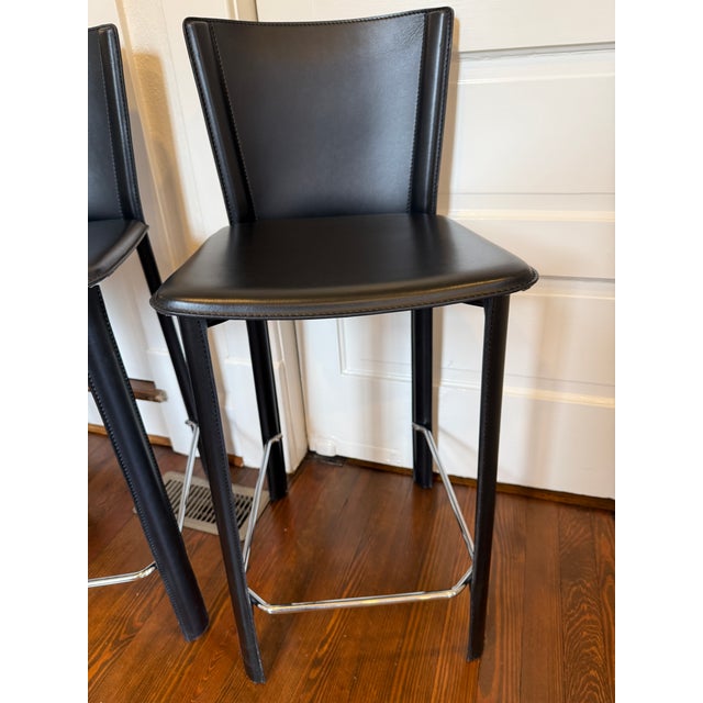 These Frag Italian black Leather countertop stools are similar in form and quality as peer Mario Bellini. The leather...