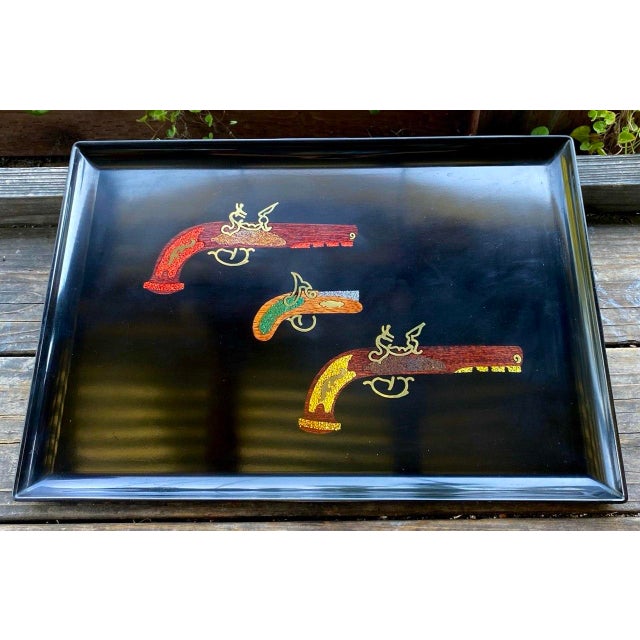 A distinctive vintage Couroc of Monterey serving tray featuring three beautifully rendered colonial-era flintlock pistols...