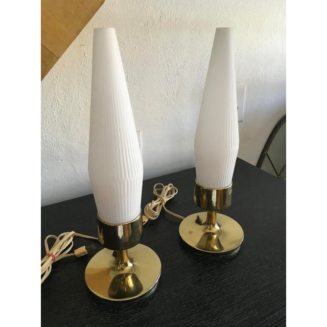 Lovely pair of petite Mid-Century Modern table lamps featuring elegant brass bases and original frosted white glass...
