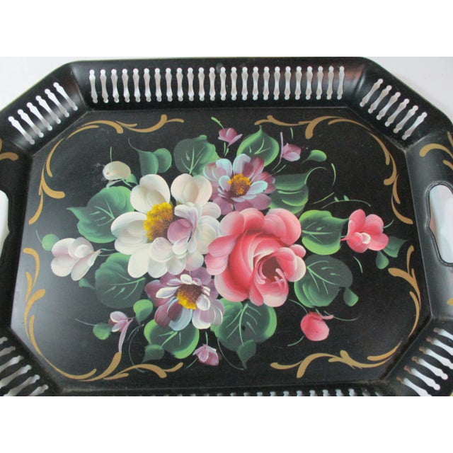 This is a wonderful vintage hand-painted tole tray with a reticulated boarder and open handles. It is decorated with a...