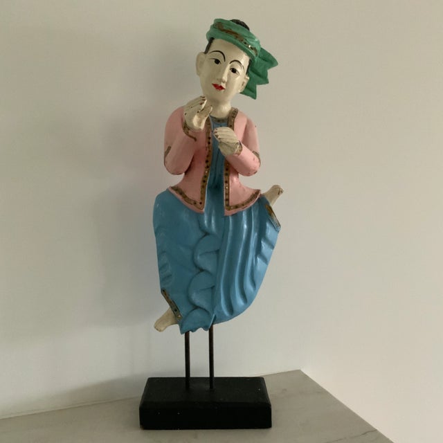 Beautiful Asian hand carved wooden figures of a woman and man playing instruments. Lovely tones of blue, turquoise and...