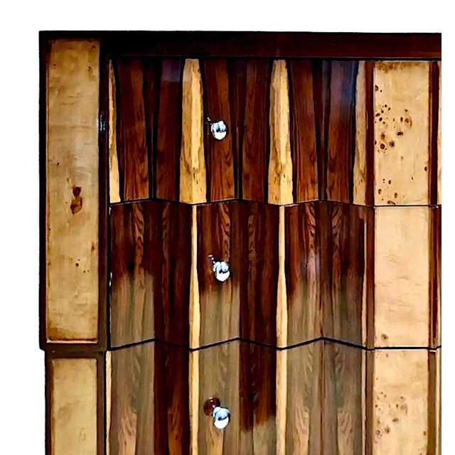 On offer is a classic Art Deco chest of drawers, remarkable for its geometric interplay of rosewood and walnut among the...