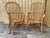 A Pair of Rattan Fan Back Lounge Chairs in the Franco Albini's Style. Circa 1980s natural rattan with woven detailing. The...