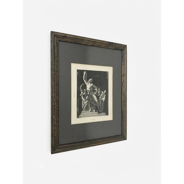 A striking black-and-white print titled Le Laocoön, depicting Laocoön and his sons entwined with serpents. Detailed...