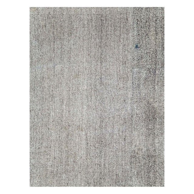 A vintage Turkish flat-weave Kilim large room size carpet handmade during the mid-20th century with a salt and pepper...