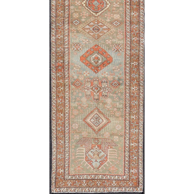 Measures: 3'4 x 15'2 Antique Persian Long Serapi Runner with Multi Medallions in Green, Blue, Orange. Keivan Woven Arts /...