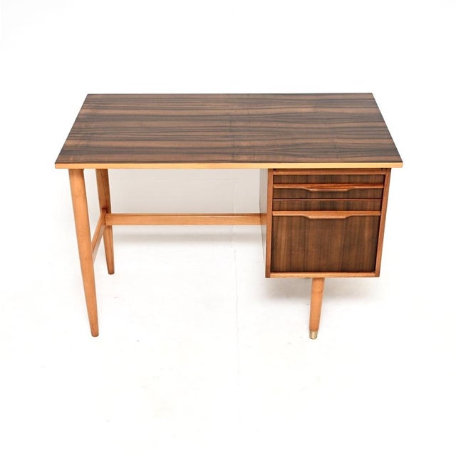 A stylish and practical vintage midcentury walnut desk. This was made in the UK, possibly by Morris of Glasgow, it dates...