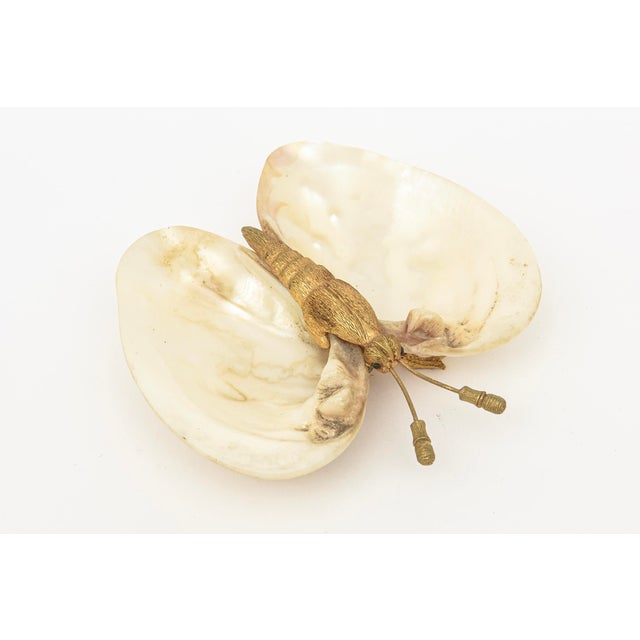This lovely 1990's shell and gold plated butterfly bowl is great for a ring dish, nightstand accessory or cocktail table...