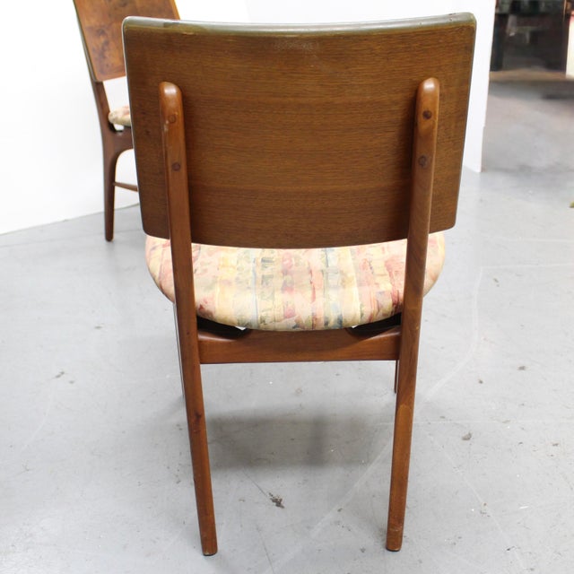 Set of four mid-century modern dining chairs from the 1970s. These side chairs feature a distinctive backrest in a variety...
