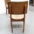 Set of four mid-century modern dining chairs from the 1970s. These side chairs feature a distinctive backrest in a variety...
