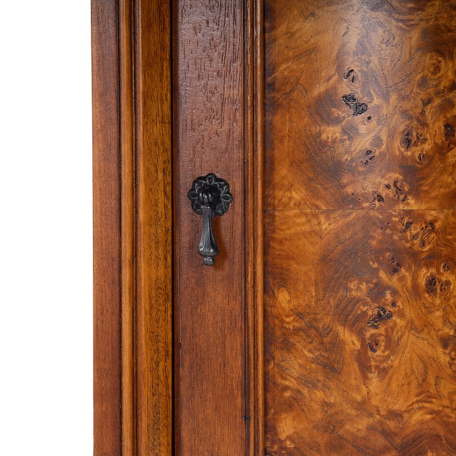 Perfect for dressing up a neglected corner, this cabinet features olive ash burl veneers along its top and door panel. The...