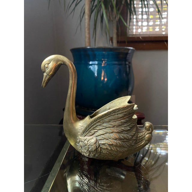This brass swan has lovely detail and a nice patina beginning to show in the feathered section. It could be used as a vase...
