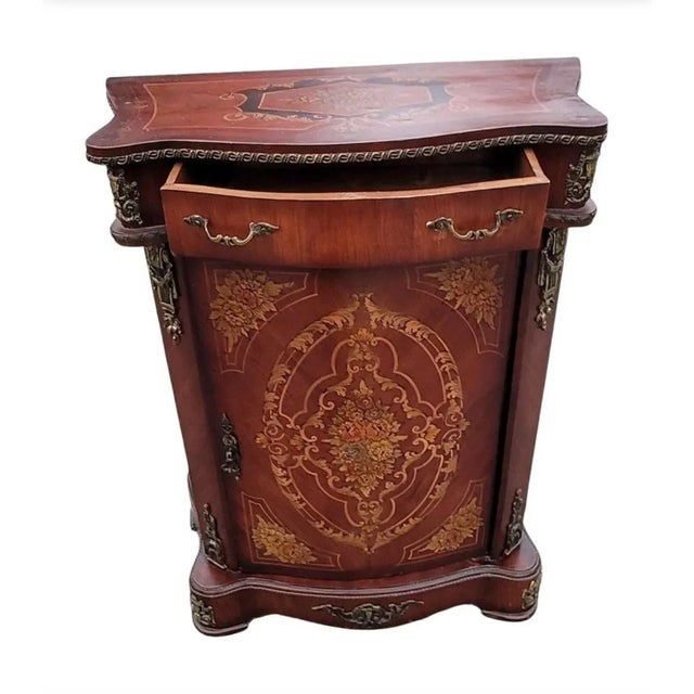 A 1940s French Continental Mahogany side console cabinet with exquisite, finely detailed Marquetry works on the front and...