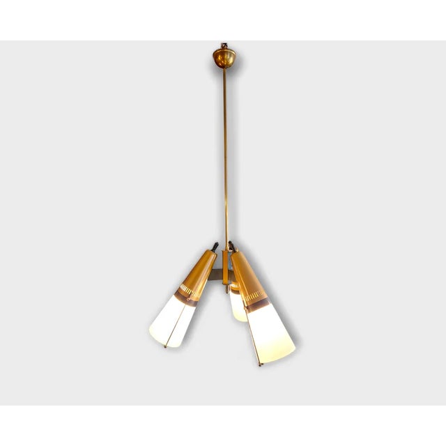 Three-light pendant chandelier produced by the Lamperti company. Lacquered metal and brass frame and conical milk glass...