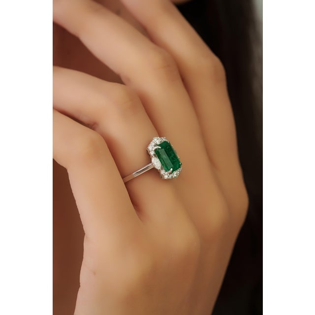 This luxurious cocktail ring features a vibrant 2.44 carat emerald Crafted in 18K white gold. The emerald measuring...