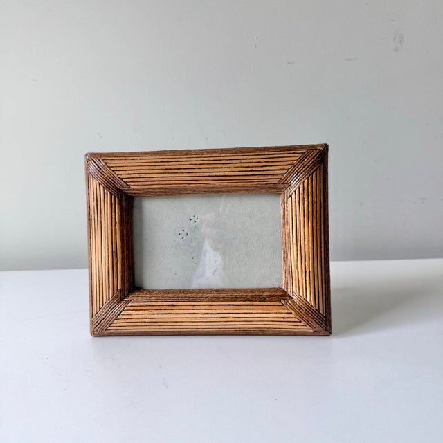 Vintage bamboo reed picture frame with glass cover. The frame fits a 6" x 4" photo and sits vertically or horizontally.