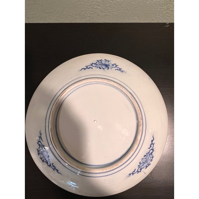 This vintage Chinese porcelain charger plate measures 12 inches in diameter. Featuring a rich cobalt blue hand-painted or...