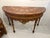 Stunning demilune (half-moon) console table featuring an elaborately inlaid marquetry top with fan, shell, and foliate...