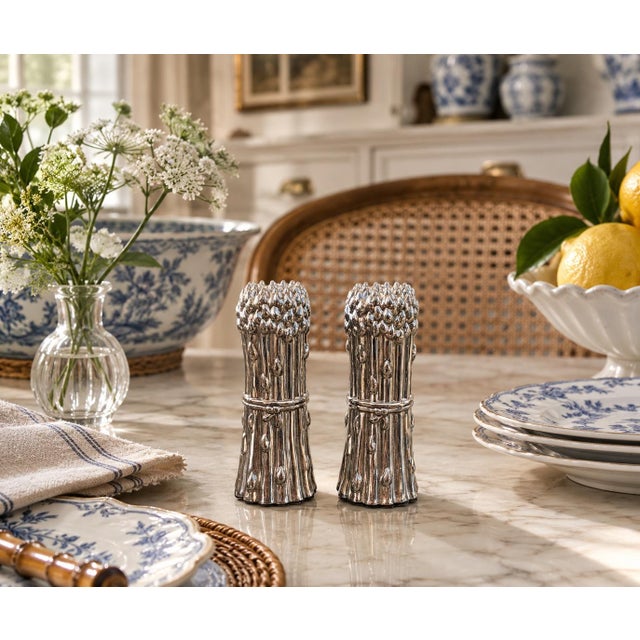 A charming pair of Godinger salt and pepper shakers cast as tightly gathered bundles of asparagus. Individually modeled...