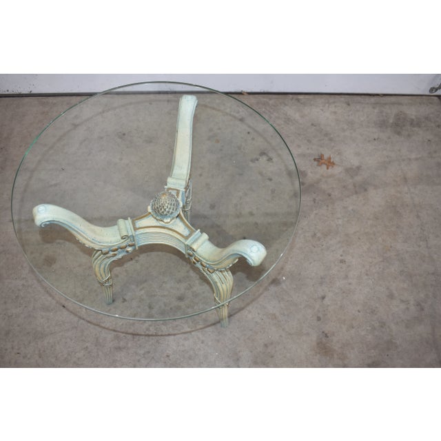 Gorgeous vintage side table made of wood with round glass top. Carved legs and details with a pineapple center. I would...