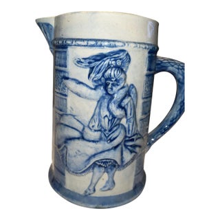 Embossed Blue and White Stoneware Pitcher by Robinson Pottery Company. For Sale