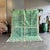 Add an elegant and calming touch to your home with this magnificent green M’rirt Moroccan rug, entirely hand-knotted in...