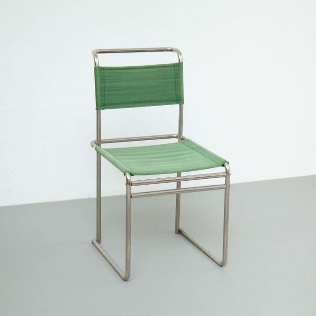 Mid-Century Modern tubular steel chair with green fabric. By unknown manufacturer from France, circa 1950. In original...