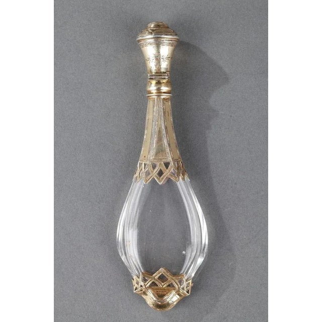 A silver mounted glass scent bottle with shaped baluster body, the part open work collar and foot are pierced and...