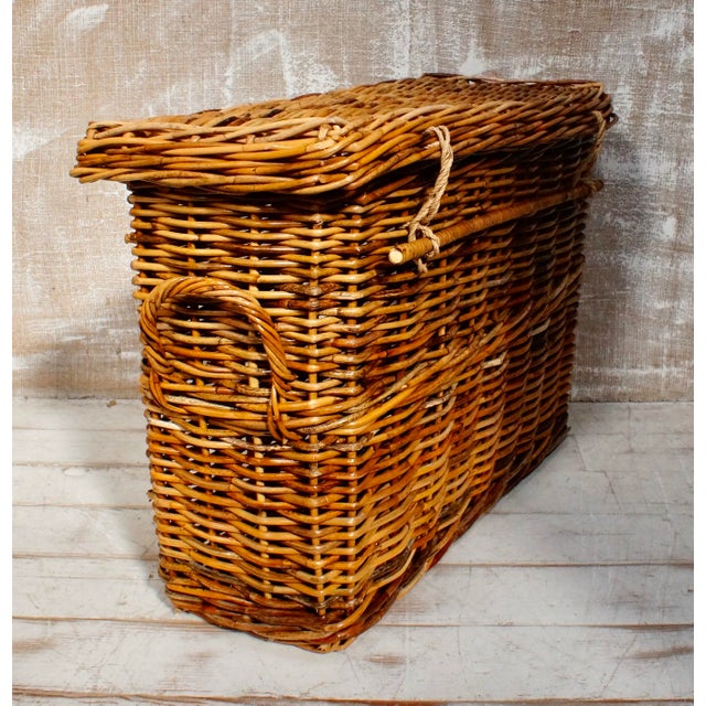 A lovely slim wicker linen or laundry basket. Made from wicker, with a two twisted wicker handles and a twisted wicker rod...
